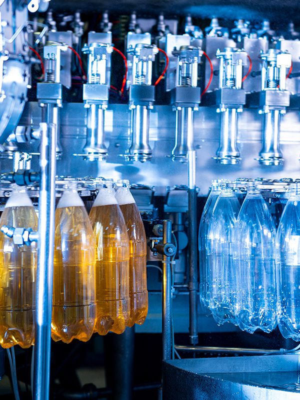 _0004_automatic-filling-machine-pours-water-into-plastic-pet-bottles-modern-beverage-plant